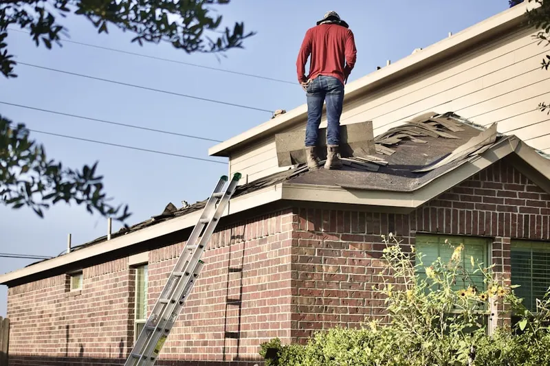 Professional roofer working on a residential roof in Manitock Spring